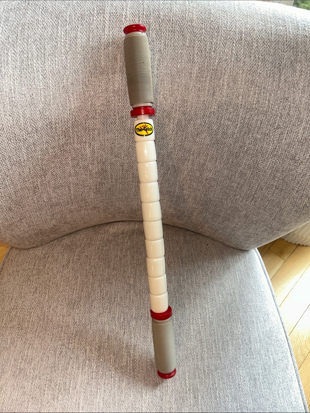 The Stick Handheld Massage Roller - Cream, Gray & Red